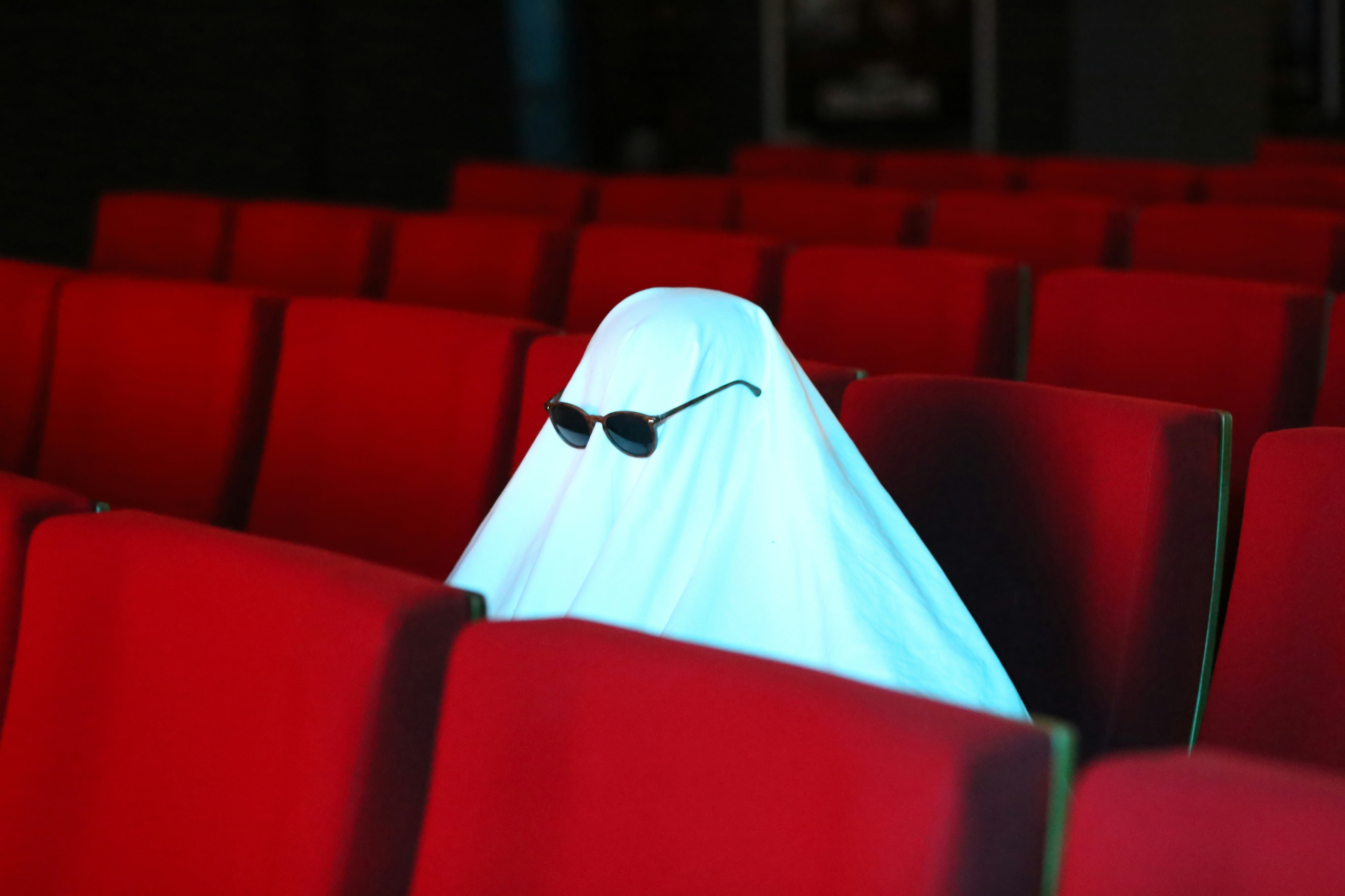 Fantasma con lentes de sol en butacas de cine